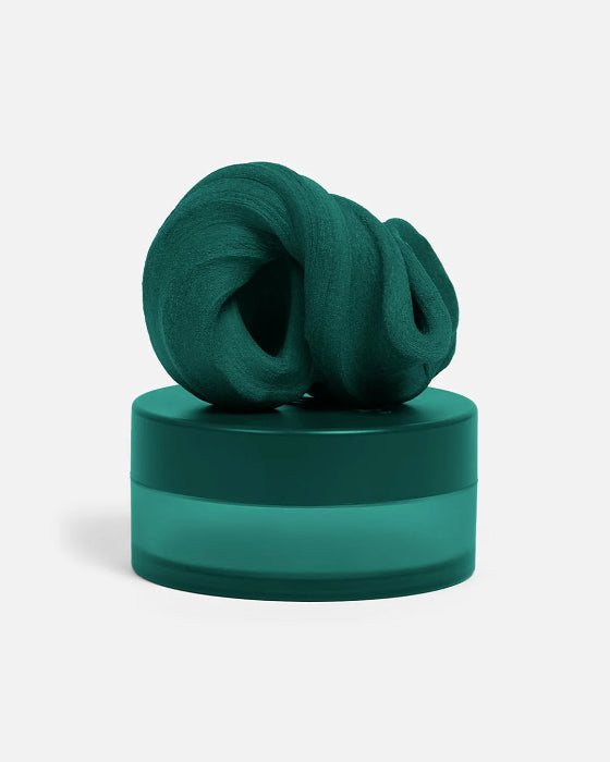 Dark teal SPEKS Blur calming focus putty twisted on its matching storage tub — Adventure Awaits