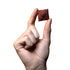 Hand holding a tiny cube of Speks rare earth fidget magnets in purple and orange - compact desk toy for adults - Adventure Awaits