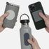Hands holding a grey tumbler, water bottle, and phone case with textured silicone fidget sticker by speks