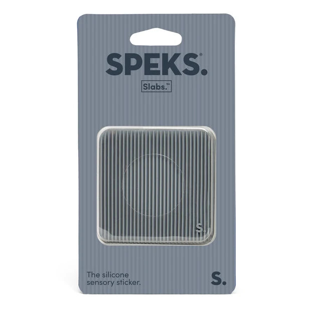 A Speks Slabs silicone sensory sticker in its retail packaging, featuring a square, ribbed gray sticker visible through a clear plastic window on a gray card backing.