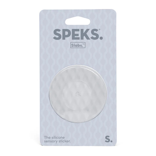 A circular clear silicone sensory sticker in its original packaging, branded SPEKS. Slabs.