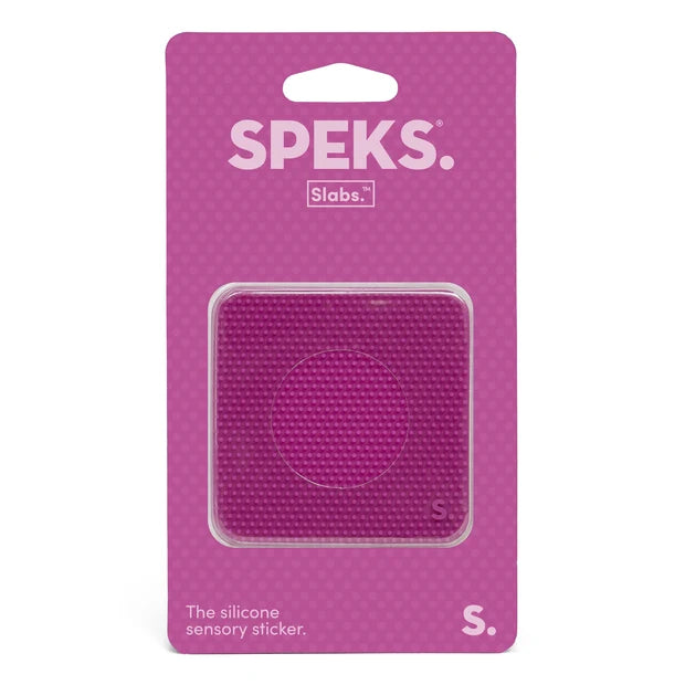 A pink textured silicone sensory sticker in a clear plastic blister pack on a pink backing card. The packaging features the brand names 'SPEKS.