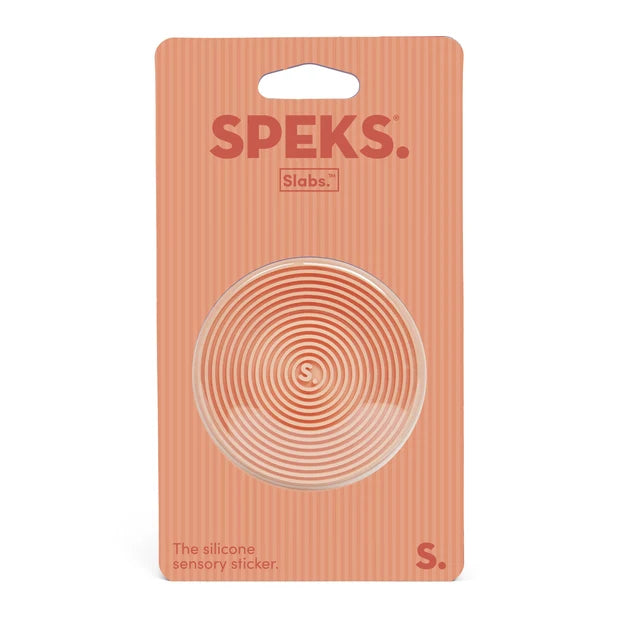 Speks Slabs S silicone sensory sticker in a peach-colored blister pack with a circular transparent sticker visible.
