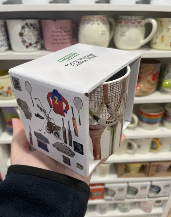 Vintage tennis racquet mug in illustrated Sporting Nation gift box, held in a shop — Adventure Awaits