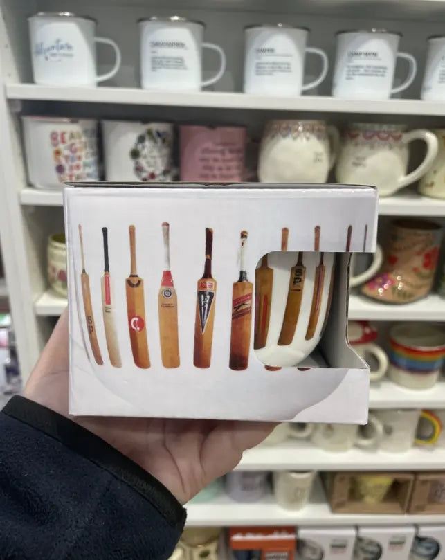 Cricketer's Tea Cup in gift box with vintage cricket bat design, held in a shop — Adventure Awaits