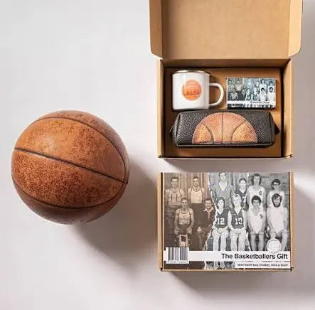 The Basketballers Gift set with enamel mug and basketball wash bag beside a vintage basketball — Adventure Awaits