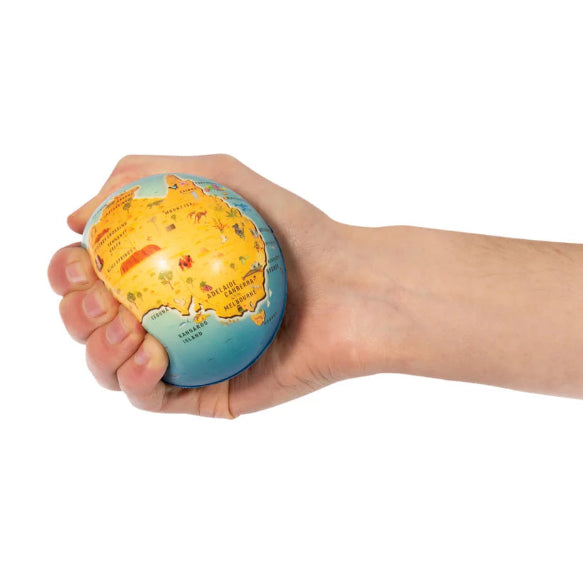 Hand holding a small globe against a white background