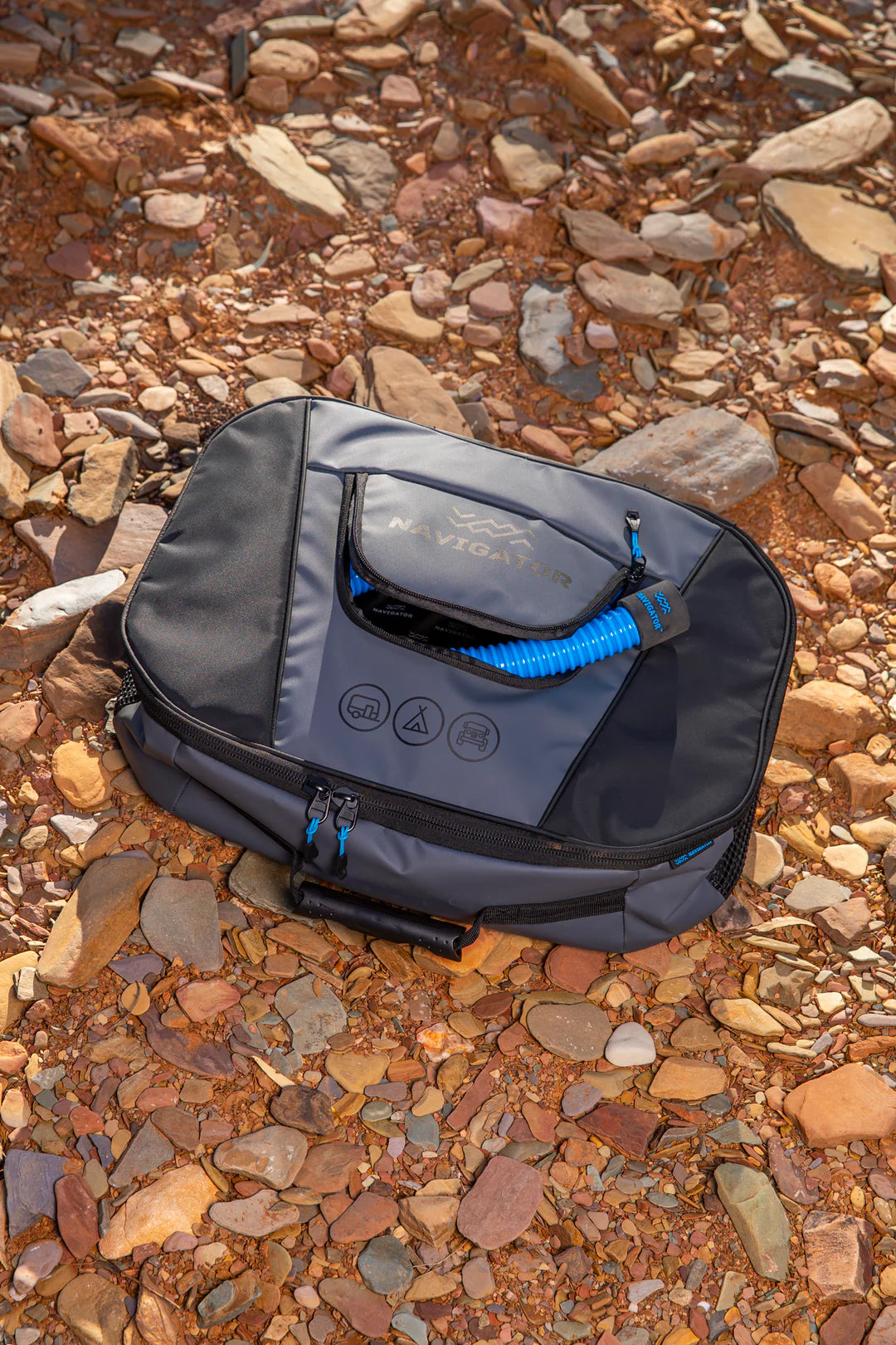 Navigator Sullage Buddy on rocky outback ground — compact sullage hose storage for caravanners — Adventure Awaits
