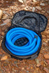 Navigator Sullage Buddy open on gravel with blue sullage hose coiled neatly inside — tidy caravan hose storage — Adventure Awaits