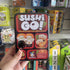 Hand holding Sushi Go card game tin in store, colourful pick and pass party game for 2 to 5 players ages 8 plus