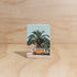 The Commonfolk kombi boho hanging air freshener with mali scent of coconut & lime on a light timber background — Adventure Awaits