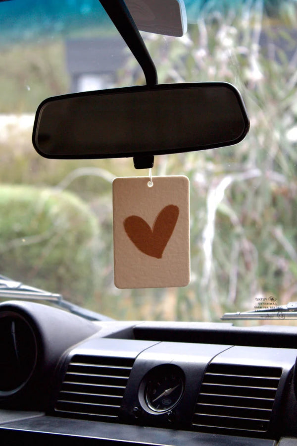 The Commonfolk warm heart boho hanging air freshener with Byron Bay scent of almond milk & coconut milk hanging on rear view mirror — Adventure Awaits