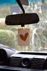 The Commonfolk warm heart boho hanging air freshener with Byron Bay scent of almond milk & coconut milk hanging on rear view mirror — Adventure Awaits
