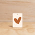 The Commonfolk Warm Heart boho hanging air freshener with Byron Bay scent of almond milk & coconut milk on a light timber background — Adventure Awaits