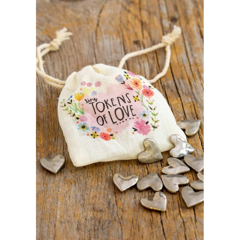 Tiny Tokens of Love drawstring bag with silver heart keepsakes on timber — Adventure Awaits
