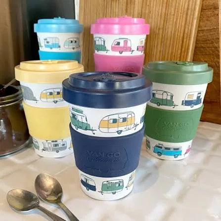 Bamboo travel mugs with caravan designs, multiple colours on table