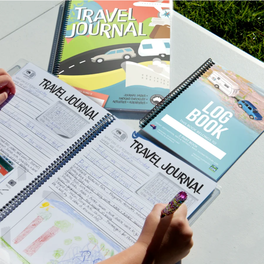 Kids Travel journal opened next to caravan and camper logbook 