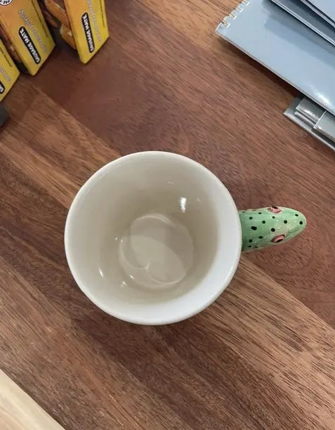 Top view of cream rainbow trout mug with green spotted fish head handle — Adventure Awaits