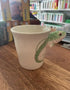 Cream rainbow trout mug with green spotted fish handle viewed from the side — Adventure Awaits