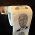 Roll of toilet paper with a printed face on a black background