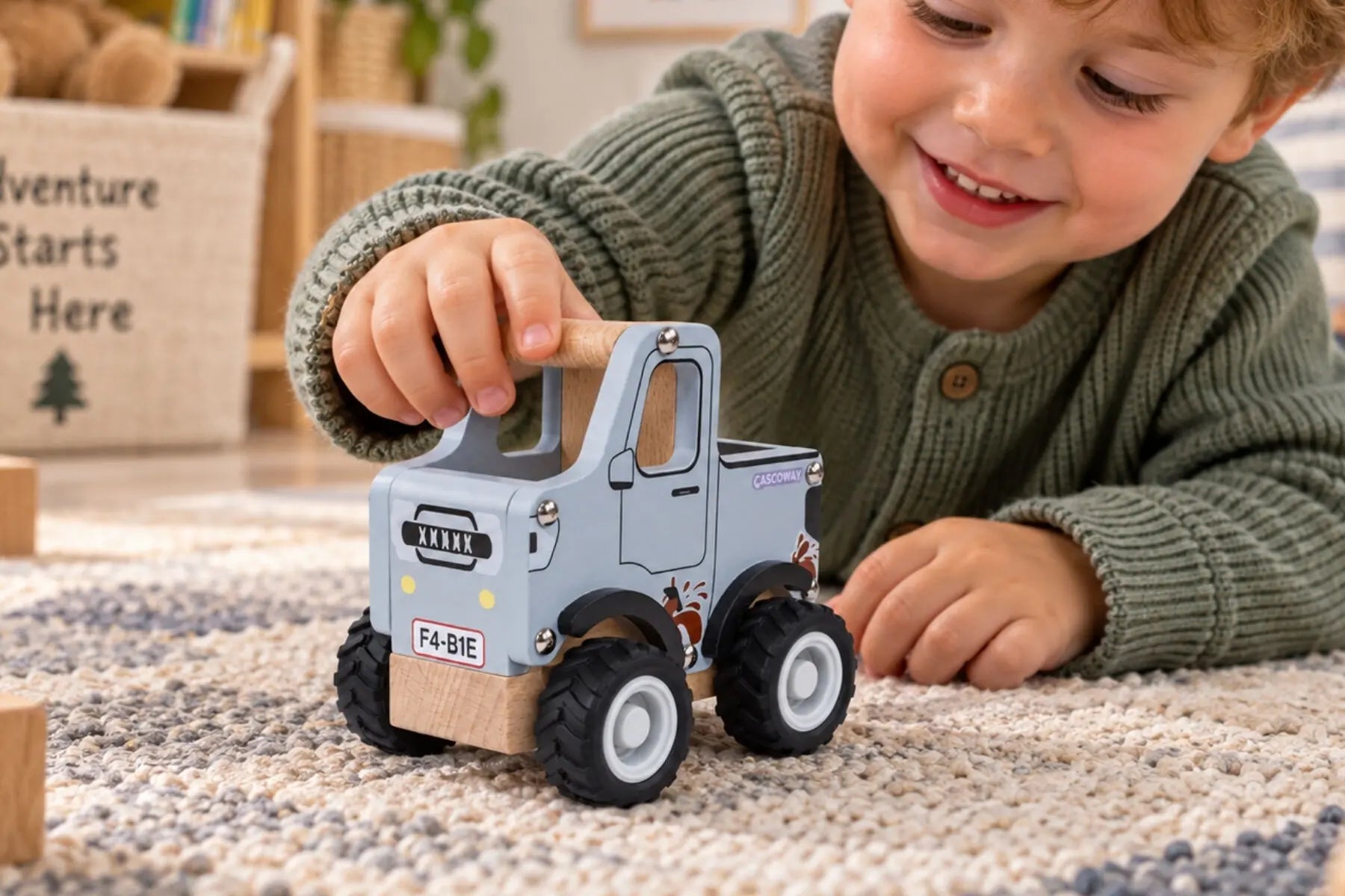 Child playing with Koala Dream grey wooden ute on a playroom rug — Adventure Awaits