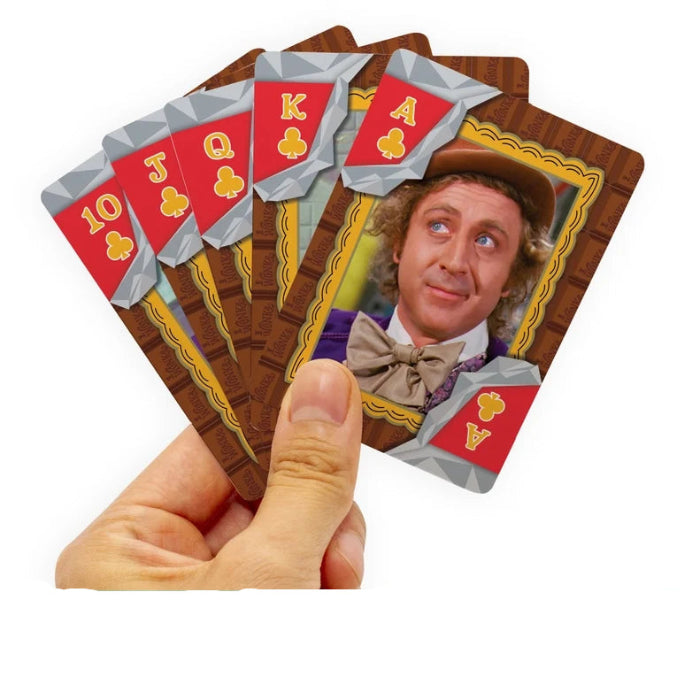 Hand holds five Willy Wonka playing cards with chocolate-themed backs and character portrait — Adventure Awaits