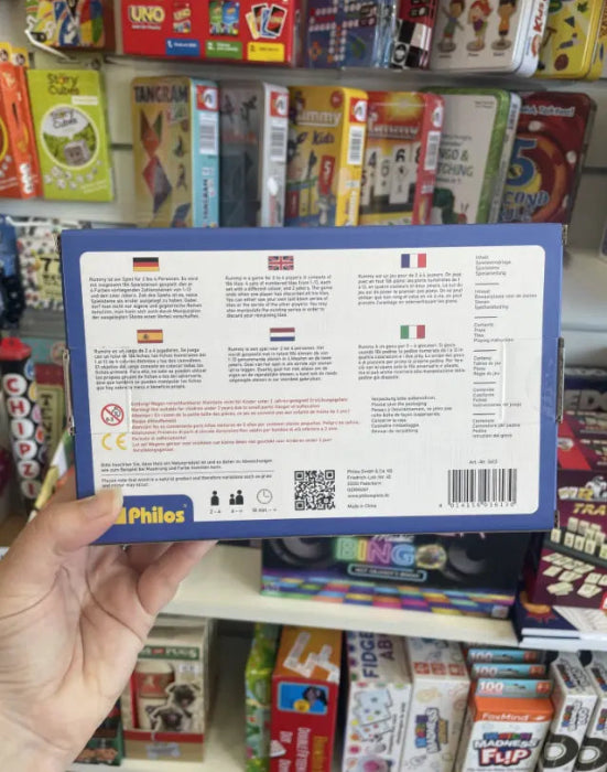 Back of Philos Rummy tile game box showing multilingual instructions, player details and product information — Adventure Awaits