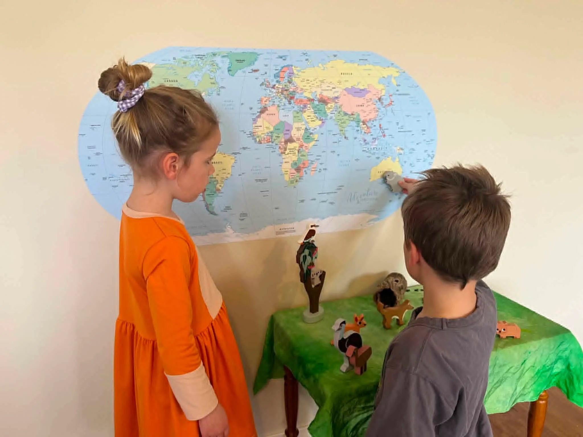 kids interacting with a Map of the World sticker from Adventure Awaits