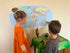 kids interacting with a Map of the World sticker from Adventure Awaits