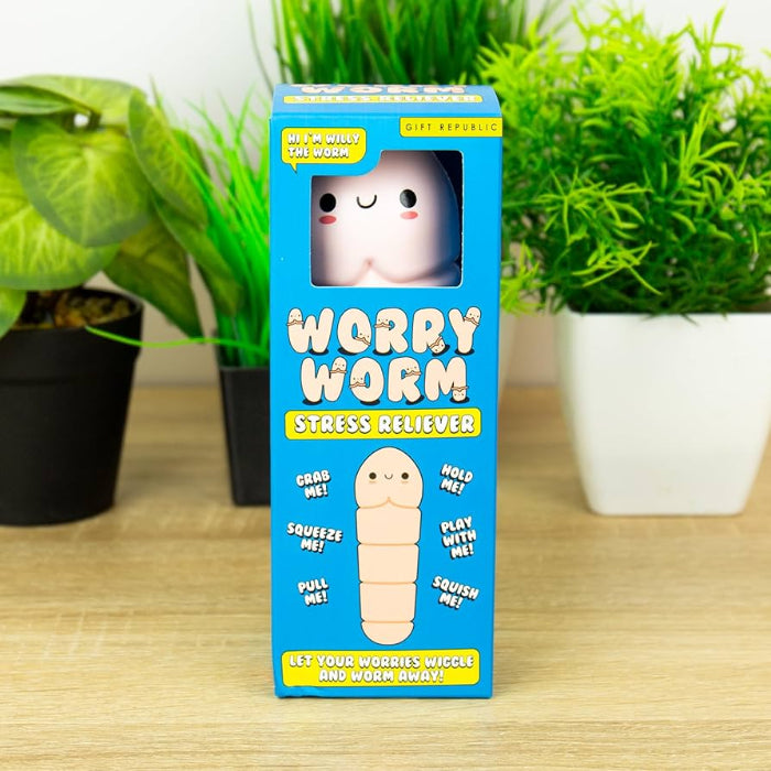 Worry Worm stress reliever in blue gift box on shelf with green plants — Adventure Awaits