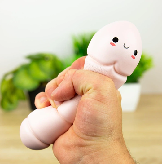Hand squeezing Worry Worm stress reliever with cute smiling face — Adventure Awaits