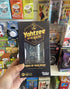 Hand holding Yahtzee On The Rocks party dice game box in front of a colourful games display — Adventure Awaits