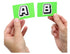 Hands holding green A and B cards from You Can't Say Umm party game — Adventure Awaits