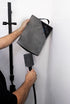 Person using grey caravan trailer plug cover on shower head for travel — Adventure Awaits