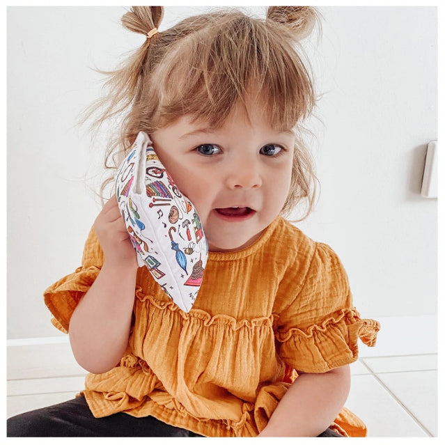 Young child holding an Ouchie Pouchie cold pack to their cheek for comfort — Adventure Awaits
