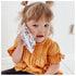 Young child holding an Ouchie Pouchie cold pack to their cheek for comfort — Adventure Awaits