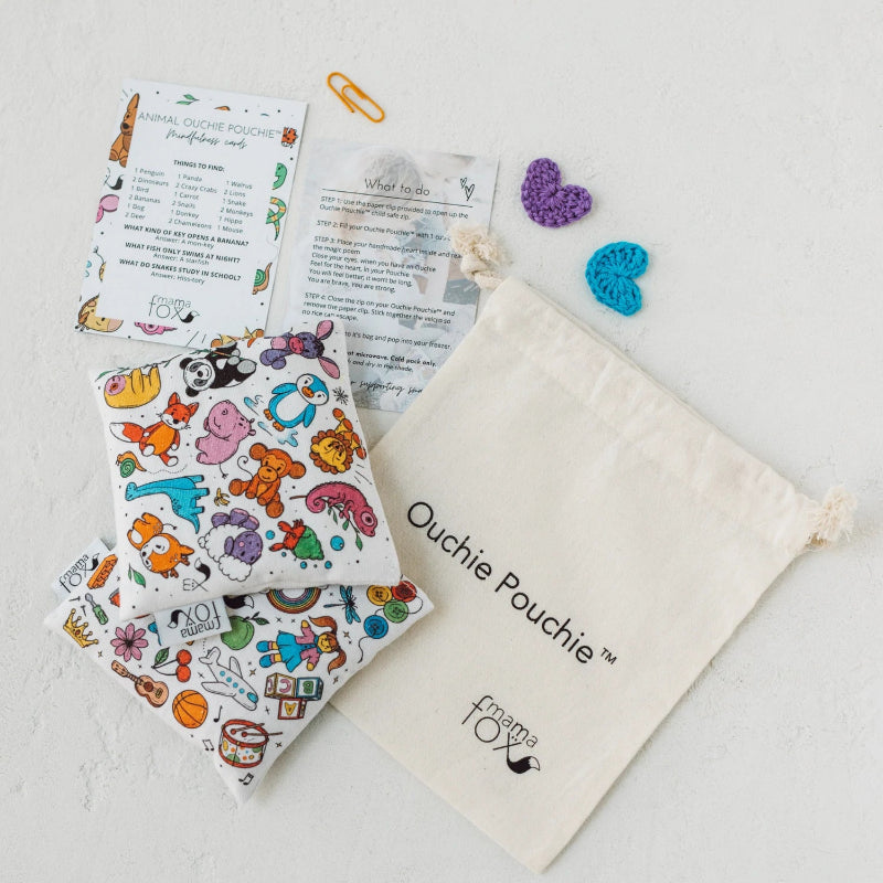 Ouchie Pouchie cold pack set with colourful illustrated pouches, cotton drawstring bag and activity cards — Adventure Awaits