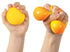 Hands squeezing a yellow NeeDoh colour-change sensory ball from round to stretched, Adventure Awaits