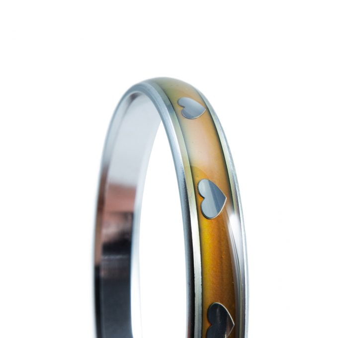 close up of Silver mood bangle with colour-changing band and white heart motifs — Adventure Awaits