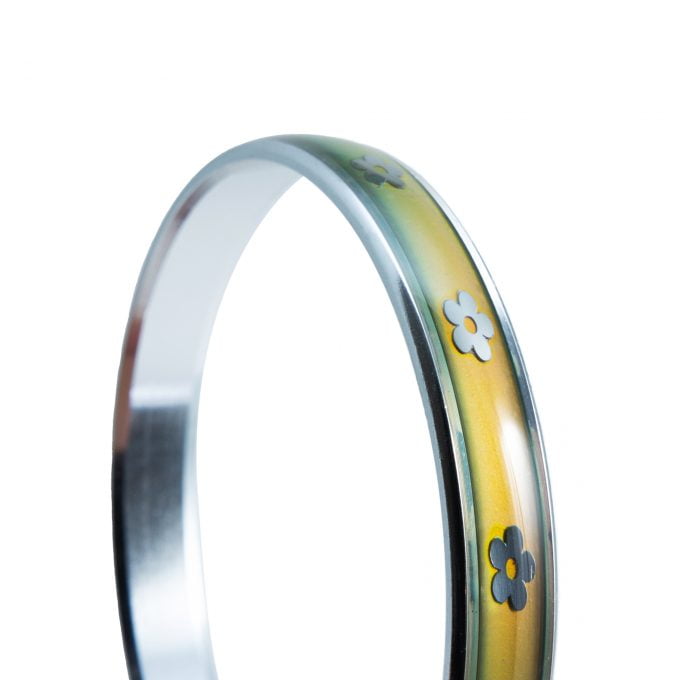 close up of Silver mood bangle with colour-changing band and white flower motifs — Adventure Awaits