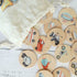 close up of some of the transport wooden memory discs white calico bag in top corner of image