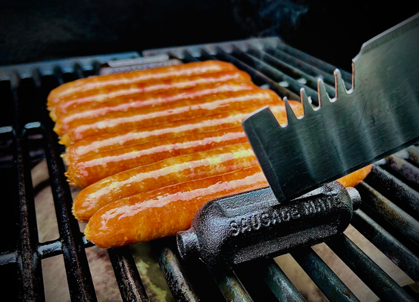 sausage mate on the grill cooking sausages perfectly - Adventure Awaits