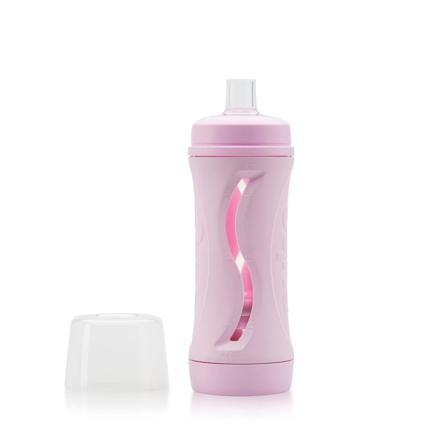 pink subo the food bottle shown with lid removed and sitting beside the bottle on a white background