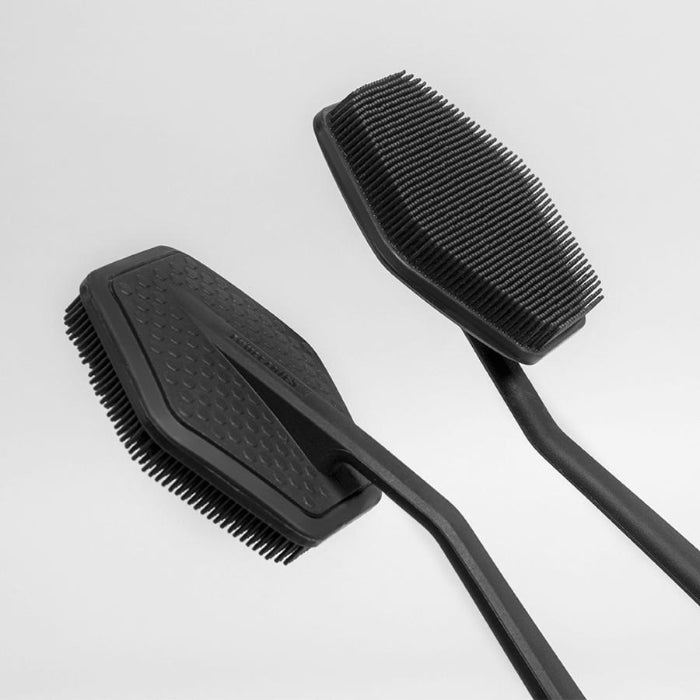 close up of front and back of black tooletries back scrubber shown on white background
