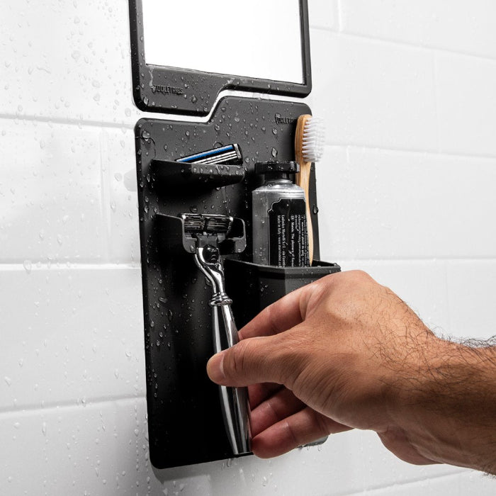 close up of man removing razor from harvey and oliver tooletries 