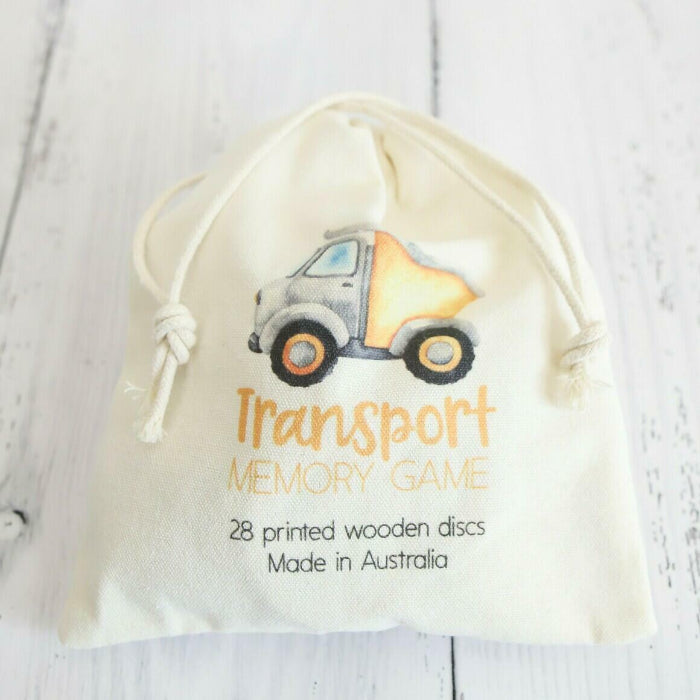bag of wooden transport memory discs on white timber background